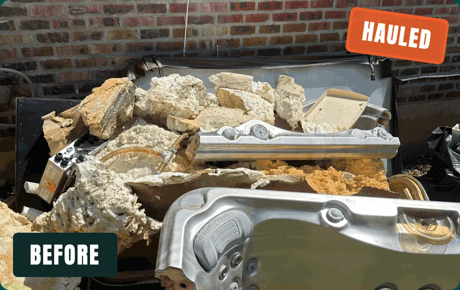 Broken-down hot tub and foam debris piled against a brick wall