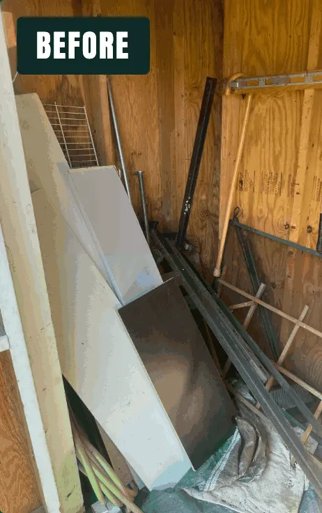 Shed packed with panels, lumber, and metal rails